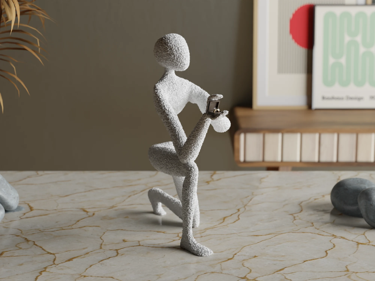 Figur på kne med ring i en boks