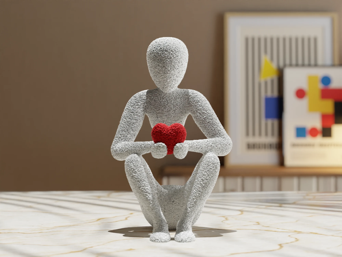Figur som holder et hjerte